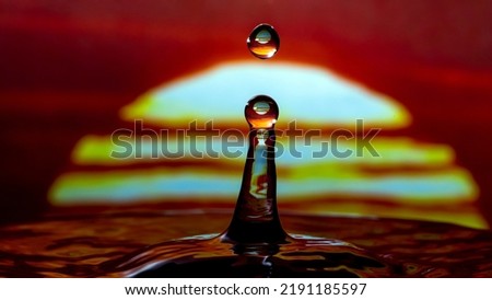 amazing beautiful unique abstract shapes are formed by collision of water droplets in different dreamy color background  
