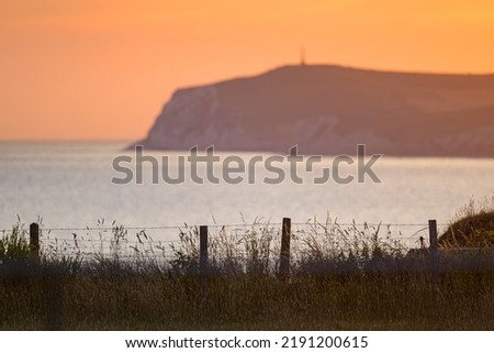 Colorful sunrise at Cap Gris Nez (France) in summer, calm sea