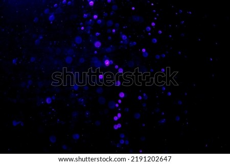 Abstract blue bokeh of water with black background