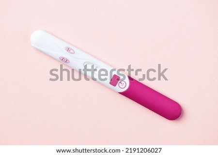 Pink positive pregnancy test on pink background. Positive result of pregnancy test. Royalty-Free Stock Photo #2191206027