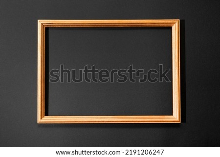 Gold frame on the black background, minimalistic card with copy space for text
