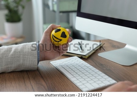 Man with antistress ball at desk in office, closeup Royalty-Free Stock Photo #2191224417