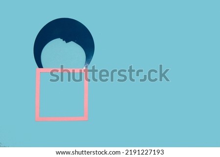 pink frame falling with the moon parachute, creative art design, copy space, blue background