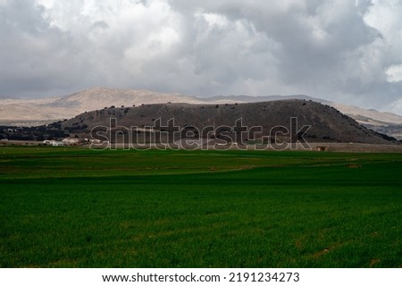Panoramic view on agricultural valley near town Zafarraya with fertile soils for growing of vegetables, green lettuce salad, cabbage, artichokes, Andalusia, Spain