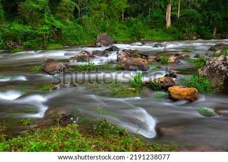 Small waterfall in  river water flowing through rocks in green forest,Champasak Province,Laos,ASIA.