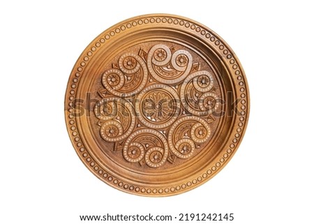 Isolated on white wooden souvenir plate with carved and decorated ornament Royalty-Free Stock Photo #2191242145