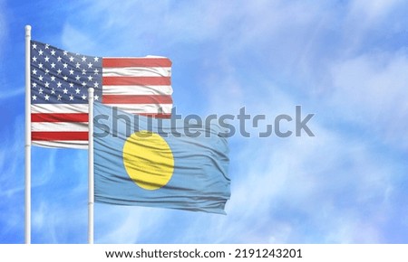 Waving American flag and flag of Palau.