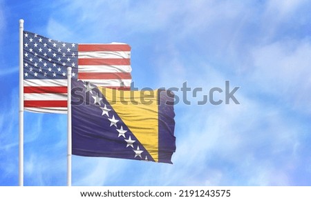 Waving American flag and flag of Bosnia and Herzegovina.