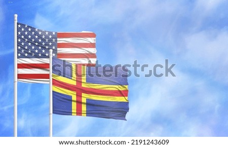 Waving American flag and flag of Aland.