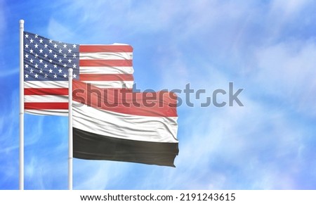 Waving American flag and flag of Yemen.