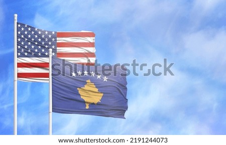 Waving American flag and flag of Kosovo.