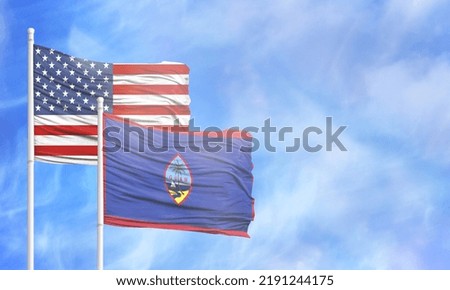 Waving American flag and flag of Guam.
