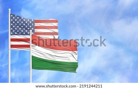 Waving American flag and flag of Hungary.