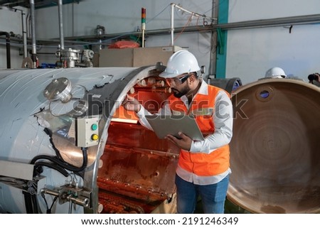 Maintenance engineer hold the laptop tablet checking specification perform boiler spray nozzle leakage check inspectiion at the pressure tank during plant inoperation outage shutdown
 Royalty-Free Stock Photo #2191246349