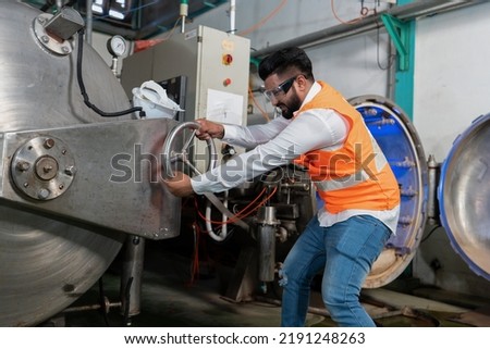 Maintenance engineer tighten closing hand wheel boiler cover during perform  spray nozzle leakage check inspectiion at the pressure tank during plant stop not operate outage shutdown
 Royalty-Free Stock Photo #2191248263