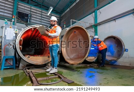 Maintenance mechanical engineer perform boiler spray nozzle leakage check inspectiion at the pressure tank during plant inoperation outage shutdown, one engineer using laptop computer recording Royalty-Free Stock Photo #2191249493