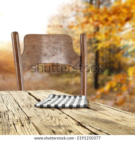 Desk of free space with napkin and autumn landscape of forest 