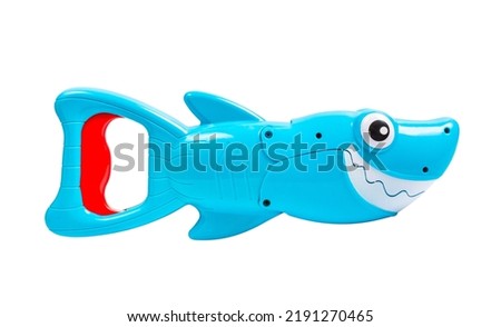 Toy shark isolated on white background. Children's toy - a cheerful shark. Plastic shark.
