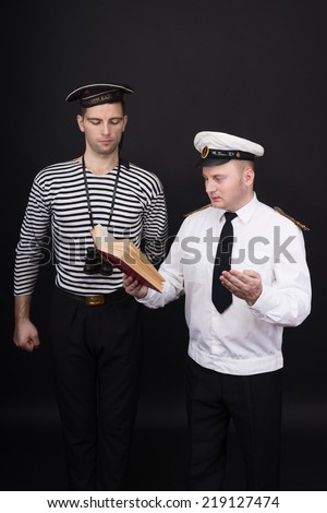 Captain reading book to the sailor