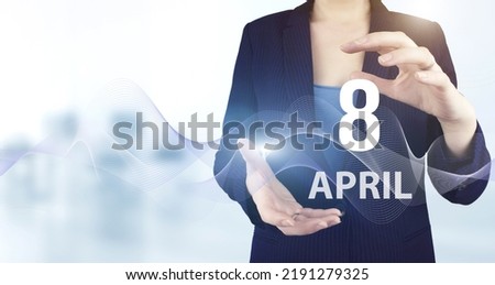 April 8th. Day 8 of month, Calendar date. Hand hold virtual hologram calendar date with digital wave.  Spring month, day of the year concept