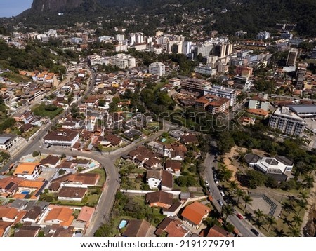 Aerial view of the city of Teresópolis. Mountains and hills with blue sky and many houses in the mountain region of Rio de Janeiro, Brazil. Drone photo. Araras, Teresópolis. Sunny day. Sunrise.