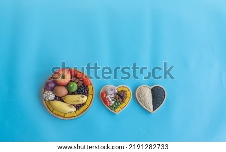 Organic  healthy  food ,grains  in  wooden  bowls  on  blue  background  for  the  health  concept . Top  view  and  copy  space for  use .