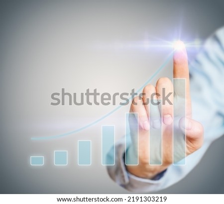 Female hand uses hologram icon - growth of business indicators, analyzing sales data and economic growth graph chart. Business strategy.