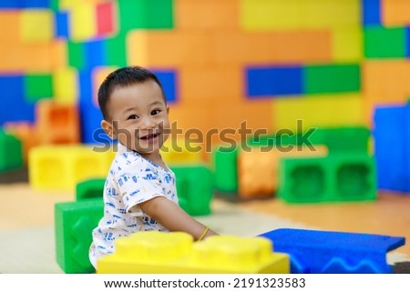 Asian cute baby is laughing and playing with toys feeling happy 