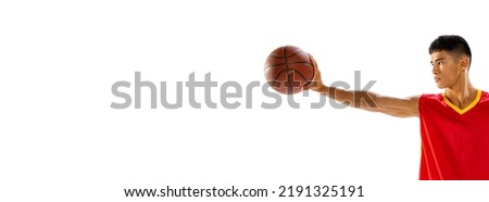 Portrait of young man, basketball player holding ball with one hand isolated over white studio background. Flyer. Concept of healthy lifestyle, professional sport, hobby, power and strength