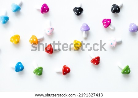 Figures in the form of colored mushrooms on a white background