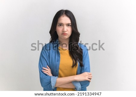 Studio portrait photo of young Asian woman with anger face expression on white background. Young woman emotion face expression portrait concept. Royalty-Free Stock Photo #2191334947