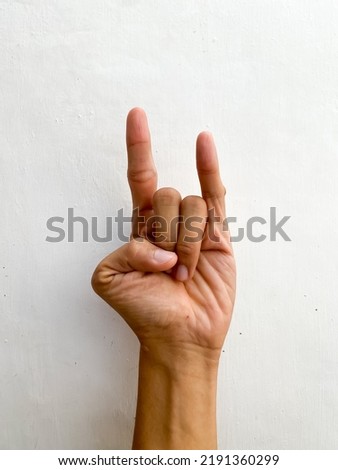 The sign of the horns hand gesture. Isolated Heavy Metal Sign.