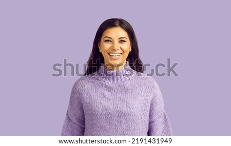 Narrow shot profile picture of overjoyed millennial Latino girl in sweater isolated on purple studio background. Headshot of excited latin young woman laugh show healthy white teeth.