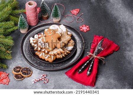 Gingerbread, Christmas tree decorations, dried citrus fruits on a gray concrete background to prepare a festive Christmas table