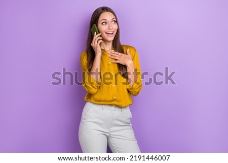 Photo of impressed brown hair lady tell telephone look promo wear brown shirt pants isolated on purple color background