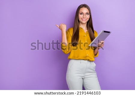 Photo of cute brown hair lady hold laptop index promo wear eyewear brown shirt pants isolated on purple color background