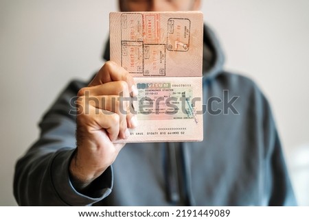 Russian foreign passport in the hands of a man. Prohibition of Schengen visas for Russian tourists to travel to the European Union during the war in Ukraine Royalty-Free Stock Photo #2191449089