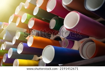 Rolls of vinyl self-adhesive film are on the shelf in the store. Sale of film for pasting cars. Production of vinyl film for tuning. Royalty-Free Stock Photo #2191452671
