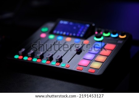 Digital music mixer and audio controller. Professional equipment for dj party, buttons, sliders, equalizer and lights. Close-up in music or recording studio
