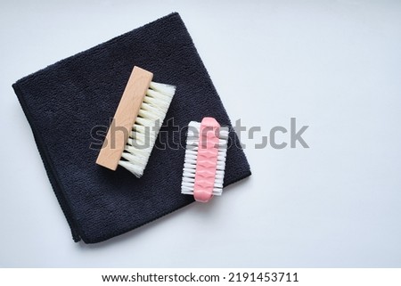 Shoe brushes and cleaning cloth close-up on a light background Royalty-Free Stock Photo #2191453711