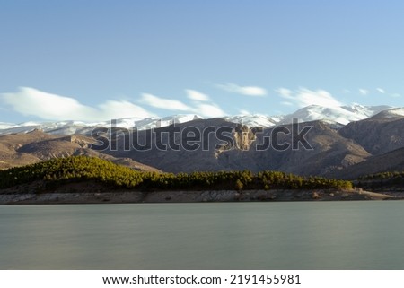 Lake and snowy mountain view, long exposure landscape.