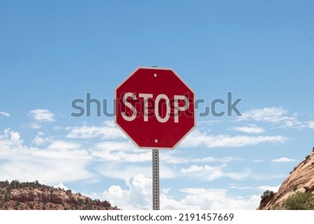 Stop sign with red and white color with blue sky background. Caution to drive with speed limit. Be careful and pay attention.