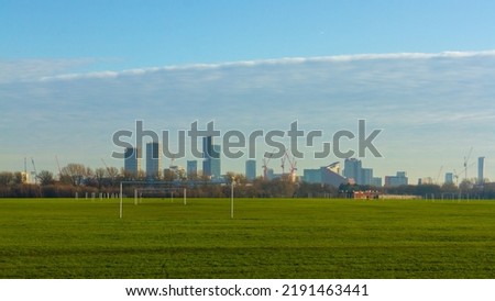 View from Hackney Marshes to Canary Wharf with loads of contrution work going om Royalty-Free Stock Photo #2191463441