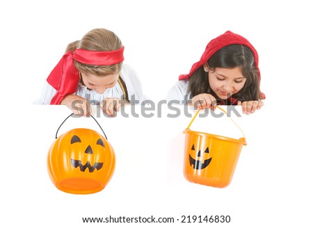Halloween: Two Girls In Costume Looking Over White Card With Buckets