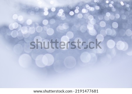 Abstract blurred gray background with circular gray and white bokeh. Blur Image of an autumn forest in evening sunset. Beautiful wallpaper.
