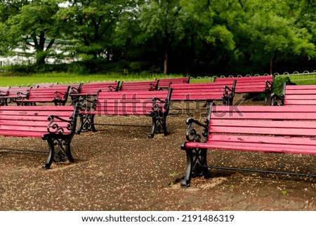 Red benches in a green forest background
