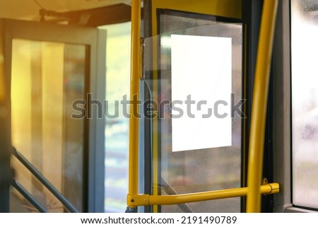 Open bus door entrance with yellow handrail and copy space empty poster on a window. Infrastructure. Door. No People. Waiting. Inside. Mock. Ride. System. Seat. Frame. Copy space Royalty-Free Stock Photo #2191490789
