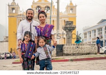 Latin family smiling looking at the camera with their two children.
Hispanic family in front of a church in a rural area. Royalty-Free Stock Photo #2191497327