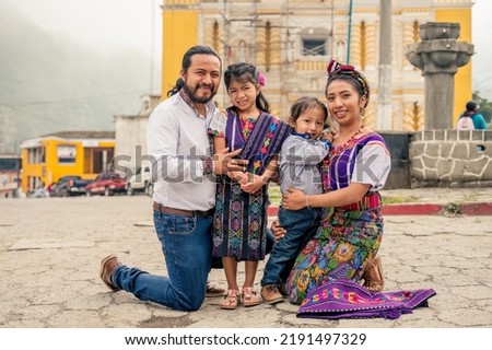 Latin family smiling looking at the camera with their two children.
Hispanic family in front of a church in a rural area. Royalty-Free Stock Photo #2191497329