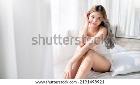 Closeup portrait of beauty asian woman with fair perfect healthy glow skin hand touching cheek chin copy space, young beautiful asia girl with pretty smile face Beauty korean women spa skincare banner Royalty-Free Stock Photo #2191498921
